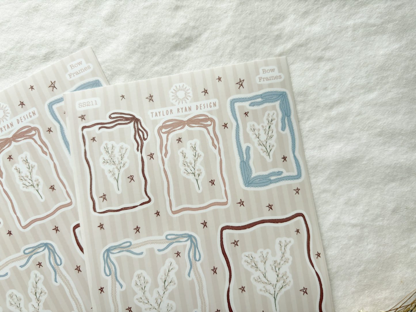 Sticker sheet with different sized frames made out of bow details. Also stickers of florals and stars.
