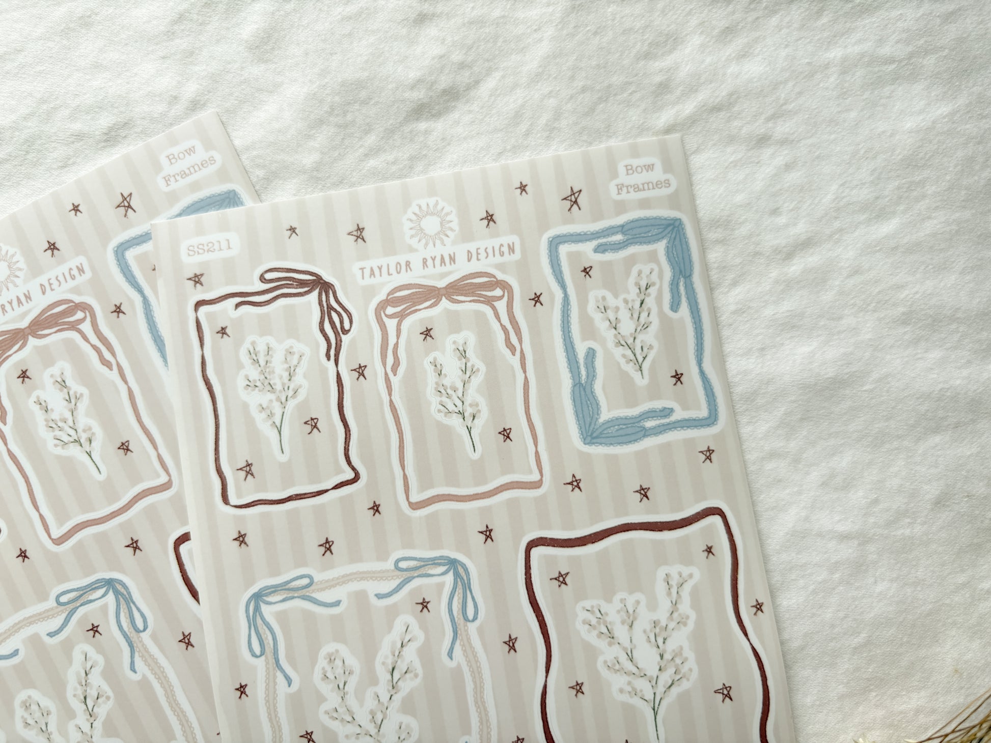 Sticker sheet with different sized frames made out of bow details. Also stickers of florals and stars.