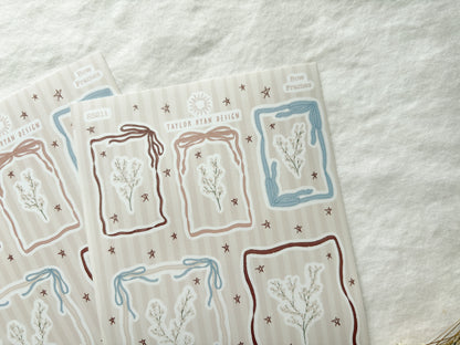 Sticker sheet with different sized frames made out of bow details. Also stickers of florals and stars.